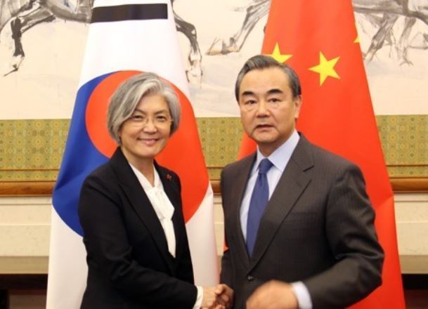 This photo, taken on Nov. 22, 2017, shows South Korean Foreign Minister Kang Kyung-wha (L) and her Chinese counterpart Wang Yi shaking hands ahead of their talks in Beijing. (Yonhap).