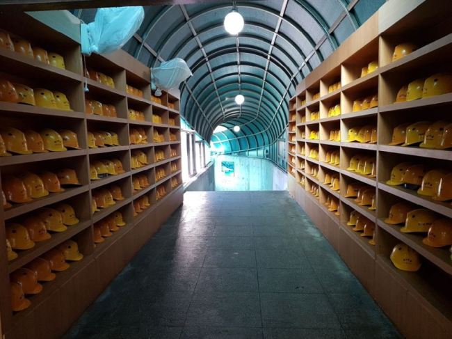 Safety helmets are provided for visitors at the entrance to the third tunnel. (Jung Min-kyung/The Korea Herald)