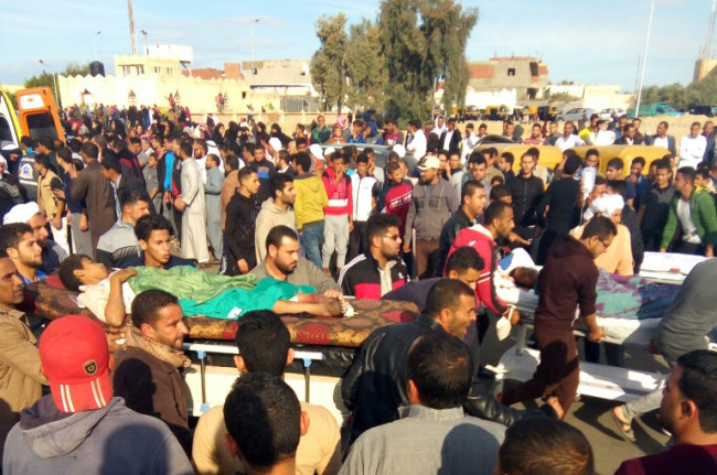 Egyptians carry victims on stretchers following an attack on the Rawda mosque in the Sinai on November 24, 2017 (AFP)