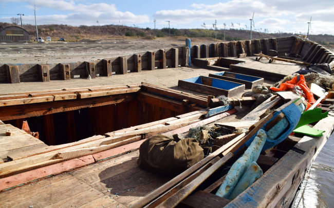 In this Monday, Nov. 27, 2017, photo, an unidentified boat is pictured in Oga, Akita prefecture, northern Japan after being washed ashore. Japan is urging local authorities and fishermen to be on the alert after several boats thought to be from North Korea were found on its northern coast. (AP)