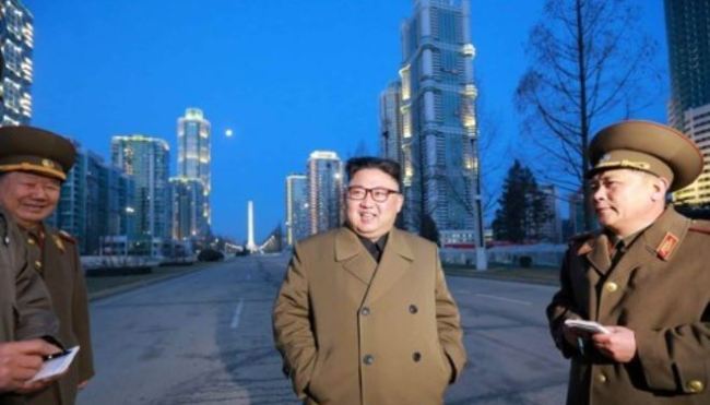This undated file photo shows North Korean leader Kim Jong-un (C) inspecting the streets of the Yeomyung district in Pyongyang. (Yonhap)