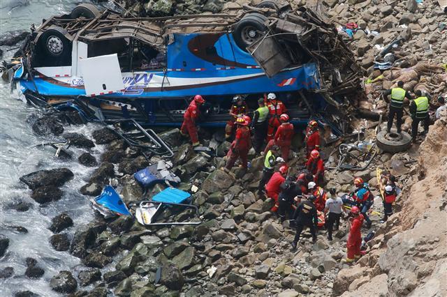 <YONHAP PHOTO-0554> Handout picture released by Peruvian agency Andina showing rescuers, police and firefighters working at the scene after a bus plunged around 100 meters (330 feet) over a cliff after colliding with a truck on a coastal highway near Pasamayo, around 45 km north of Lima, and killing at least 25 people on January 2, 2018. "At least 25 people are dead and around five are injured among those found so far," the head of the police's highway patrol division, Colonel Dino Escudero, said. The bus was travelling from Huacho, 130 km north of the capital, to Lima with 53 passengers on board. The spot where the accident occurred is known as the "devil's curve." / AFP PHOTO / ANDINA / HO / RESTRICTED TO EDITORIAL USE - MANDATORY CREDIT "AFP PHOTO / ANDINA / HO" - NO MARKETING NO ADVERTISING CAMPAIGNS - DISTRIBUTED AS A SERVICE TO CLIENTS/2018-01-03 05:46:46/ <저작권자 ⓒ 1980-2018 ㈜연합뉴스. 무단 전재 재배포 금지.>