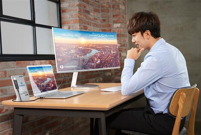 삼성전자 모델이 차세대 데이터 전송 규격인 ‘썬더볼트3’를 지원하는 커브드 모니터 신제품 CJ791을 사용하고 있다.  [제공=삼성전자]