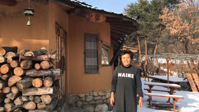 Airbnb host Yoon In-sook at her clay house "Makashe" in Jeongseon, Gangwon Province. (Lim Jeong-yeo/The Korea Herald)