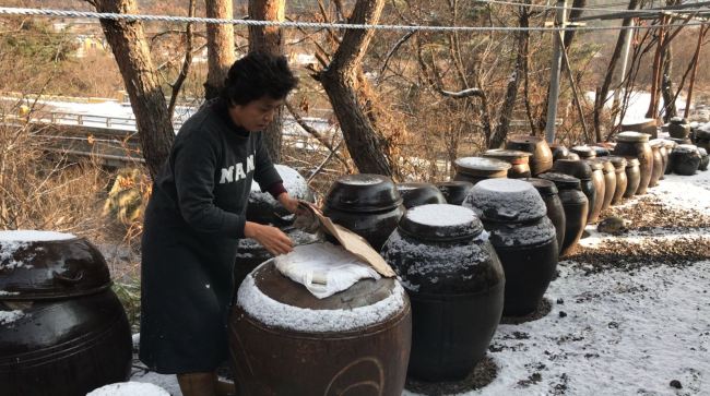 Airbnb host Yoon In-sook at her clay house "Makashe" in Jeongseon, Gangwon Province. (Lim Jeong-yeo/The Korea Herald)