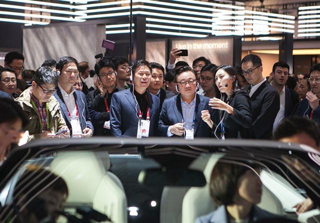 박정호 SK텔레콤 사장(가운데 왼쪽)이 9일(현지시간) ‘CES 2018’의 삼성전자 부스에서 고동진 삼성전자 사장(가운데 오른쪽)과 함께 IoT 기술과 전장기술이 접목된 ‘디지털 콕핏’ 등을 살펴보고 설명을 듣고 있다.  [제공=SK텔레콤]