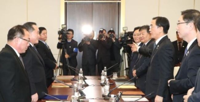 This photo, taken by the Joint Press Corps on Jan. 9, 2018, shows negotiators from South Korea (R) and North Korea after high-level talks at the border truce village of Panmunjom. (Yonhap)