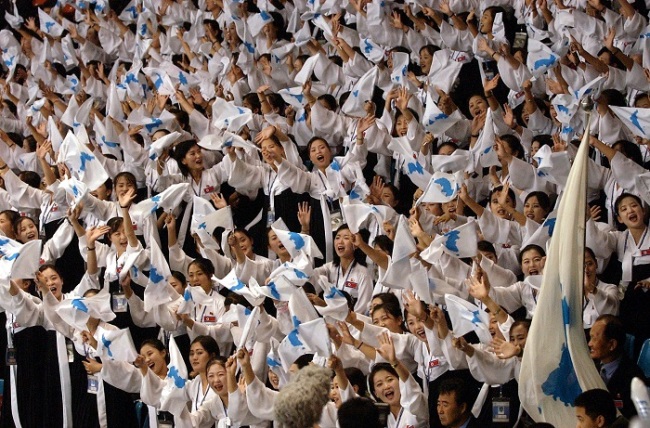 North Korean cheerleaders cheer for South Korean athletes at the 2003 Summer Universiade held at the Daegu World Cup Stadium in South Korea. (Yonhap)
