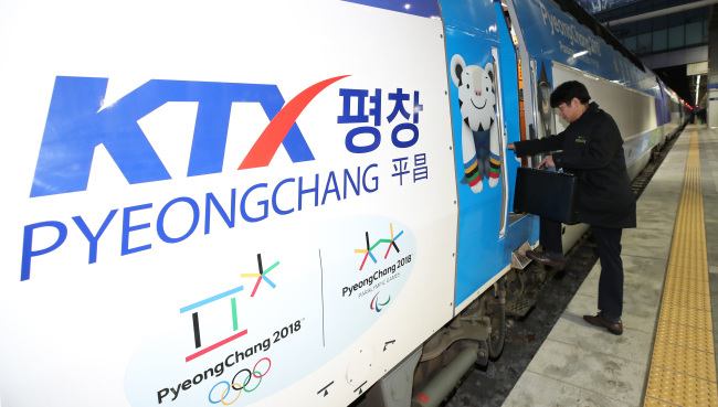 A man boards a KTX train that bears advertising for the PyeongChang Olympics, which run from Feb. 9-25. (Yonhap)