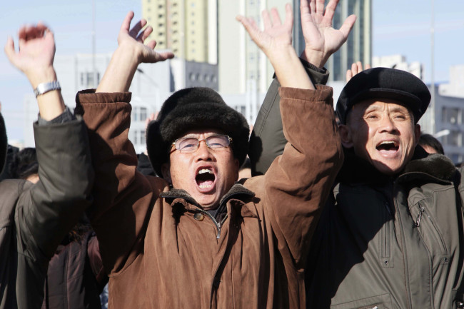 In this Wednesday, Nov. 29, 2017, file photo, people cheer as they watch the news broadcast announcing North Korean leader Kim Jong Un's order to test-fire the newly developed inter-continental ballistic missile Hwasong-15 at the Pyongyang Train Station in Pyongyang, North Korea. (AP-Yonhap)