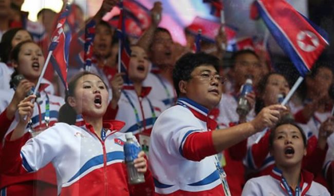This file photo taken on Sept. 27, 2014, shows North Koreans supporting their athletes in the men's wrestling competition at the Asian Games in Incheon. (Yonhap)