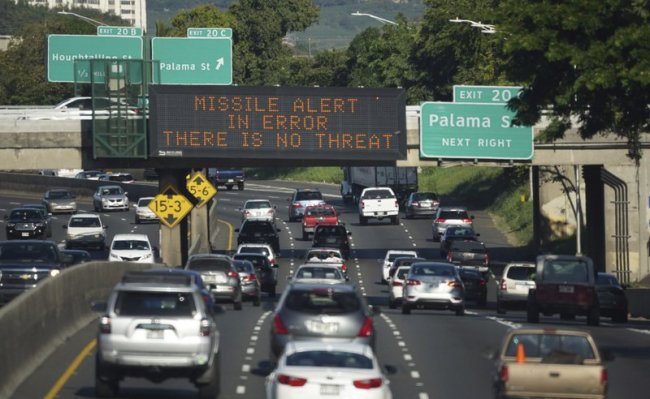In this Saturday, Jan. 13, 2018 photo provided by Civil Beat, cars drive past a highway sign that says “MISSILE ALERT ERROR THERE IS NO THREAT” on the H-1 Freeway in Honolulu. (AP)