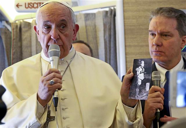 <YONHAP PHOTO-7320> epa06440397 Pope Francis holds a picture depicting a Nagasaki victim as he speaks to reporters onboard the plane that departed Rome for his trip to Chile and Peru, 15 January 2018. The pontiff is visiting Chile from January 15-18, then will head to Peru, where he'll stay until January 21. EPA/ALESSANDRO BIANCHI / POOL/2018-01-15 20:41:06/ <저작권자 ⓒ 1980-2018 ㈜연합뉴스. 무단 전재 재배포 금지.>