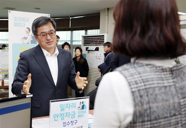 김동연 경제부총리 겸 기획재정부 장관이 15일 오후 인천시 서구 가좌2동 주민센터를 방문해 일자리안정자금 접수 현황을 담당 공무원에게 문의하고 있다. 일자리안정자금은 올해부터 최저임금이 7530원으로 지난해보다 16.4% 인상됨에 따라 인건비 부담이 커진 소상공인과 영세기업을 지원하는 제도다.  [연합뉴스]