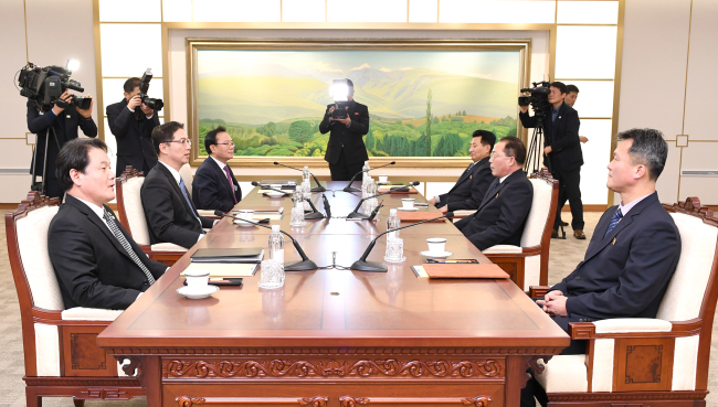 This photo, provided by Seoul's Unification Ministry on Wednesday, shows working-level talks between the two Koreas on the North's participation in the PyeongChang Winter Olympics. (Yonhap)