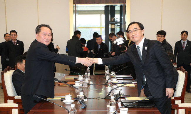 South Korea's Unification Minister Cho Myoung-gyon (R) shakes hands with North Korean chief delegate Ri Son-gwon during their meeting at the border truce village of Panmunjeom in the Demilitarized Zone dividing the two Koreas on January 9, 2018.