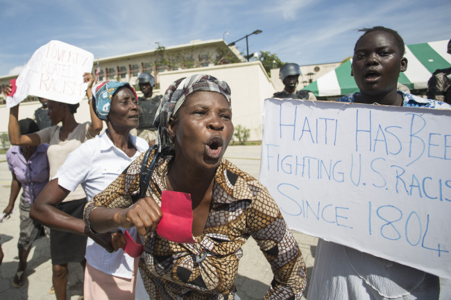 Haitians gather in front of the US Embassy in Port-au-Prince during a sit-in to express their dissatisfaction with the recent remarks that have been made about Haiti by US President Donald Trump. US President Trump's reported reference to African nations and Haiti as "shithole countries" ignited a still smoldering political firestorm. (AFP-Yonhap)
