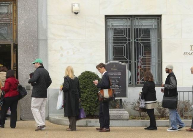 People wait in line at Dirksen Senate Office building at one of the few entrances opened for staff members at the U.S. Capitol in Washington as Day Three of the government shutdown continues on Monday, Jan. 22, 2018. (AP)