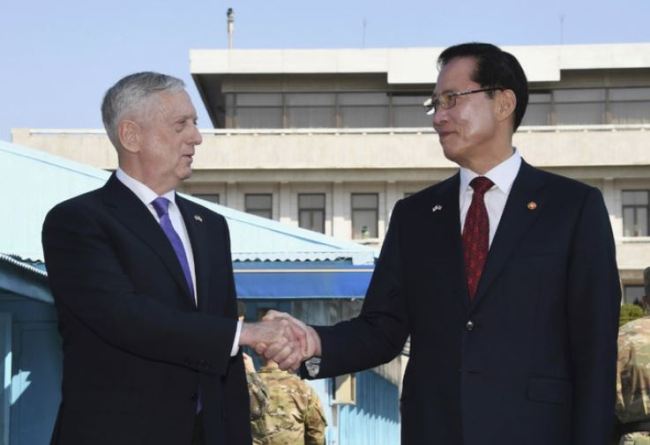 United States Defense Secretary Jim Mattis (l.) shakes hands with South Korean Defense Minister Song Young-moo as they visit the truce village of Panmunjom. (AP)