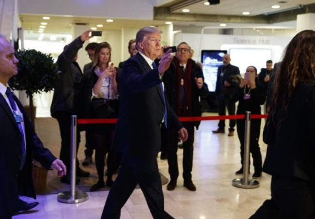 US President Donald Trump waves as he walks to a dinner with European business leaders at the World Economic Forum, Thursday, Jan. 25, 2018, in Davos. (AP