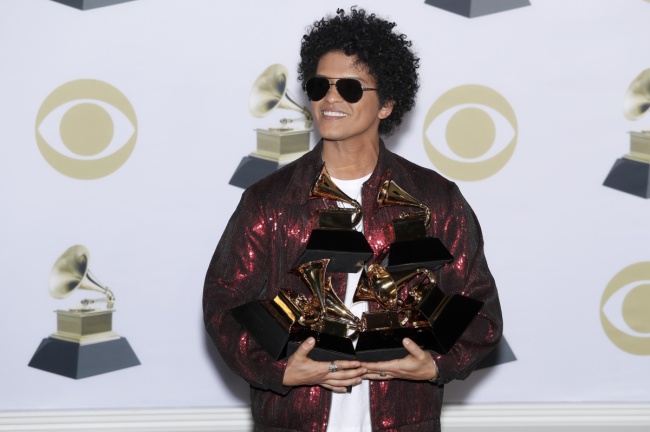 Bruno Mars poses with his six Grammys in the pressroom during the 60th annual Grammy Awards ceremony at Madison Square Garden in New York. (EPA-Yonhap)