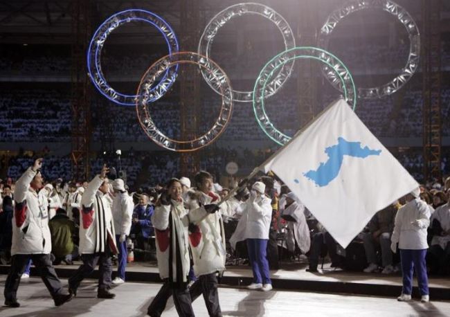 In this Feb. 10, 2006, file photo, Korea flag-bearer's Bora Lee and Jong-In Lee, carrying a unification flag lead their teams into the stadium during the 2006 Winter Olympics opening ceremony in Turin, Italy. (AP)
