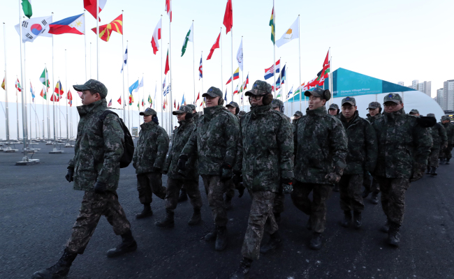A group of enlisted soldiers enters the Olympic Village for the PyeongChang Olympics in Gangneung, Gangwon Province, on Feb. 5, 2018, to conduct a security check. (Yonhap)