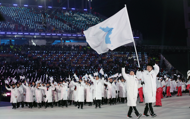 Select athletes and Olympic officials of the two Koreas enter the PyeongChang Olympic Stadium in PyeongChang, host city of South Korea's first Winter Games, at the Olympics' opening ceremony on Feb. 9, 2018. (Yonhap)