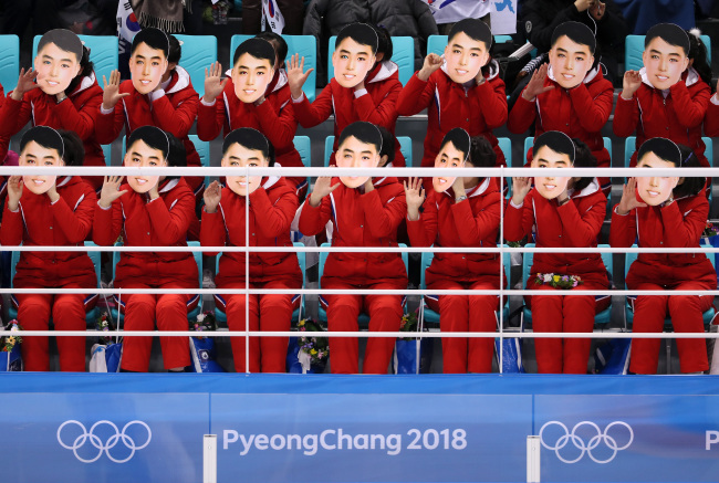 North Korean supporters cheer on the unified Korean women’s hockey team’s match against Switzerland at Kwandong Hockey Center in Gangneung, Gangwon Province, Saturday. (Yonhap)