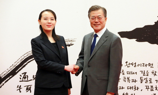 South Korea's President Moon Jae-in shakes hands with Kim Yo-jong, younger sister of North Korea's leader Kim Jong-un. Yonhap