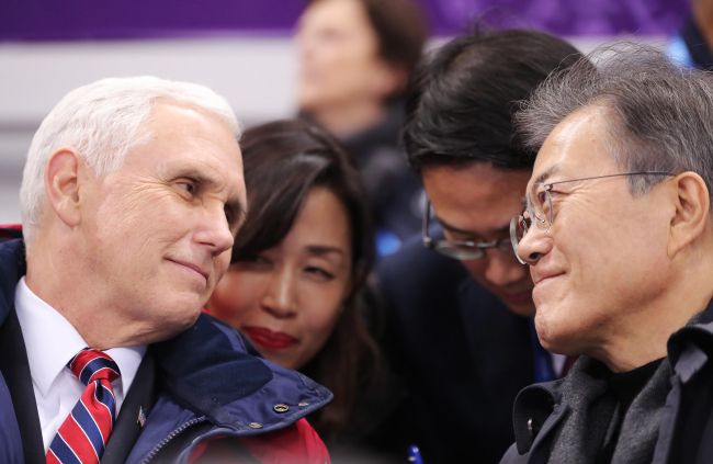 This photo, provided by South Korea's presidential office, shows South Korean President Moon Jae-in (R) and U.S. Vice President Mike Pence (L) watching a short-track speedskating event in Gangneung, South Korea, on Feb. 10, 2018. (Yonhap)