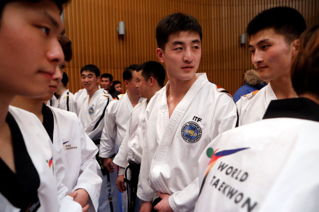 North Korean taekwondo demonstration team members and South Korean team cheer each other after performing together at the Joint Taekwondo performance of World Taekwondo and International Taekwondo Federation, Seoul, South Korea February 12, 2018. (Reuters)