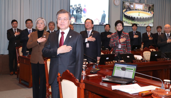 President Moon Jae-in and other Cabinet members pledge allegiance to the flag ahead of a video conference on Tuesday. (Yonhap)