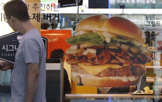 A consumer walks by a McDonald's store in Seoul. (Yonhap)