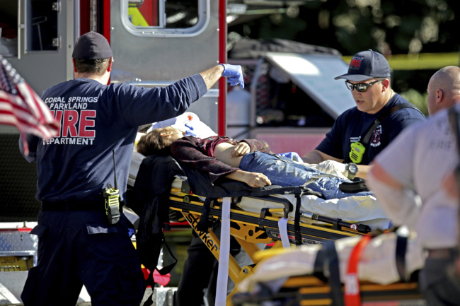 Medical personnel tend to a victim following a shooting at Marjory Stoneman Douglas High School in Parkland, Fla., on Wednesday, Feb. 14, 2018. (AP)