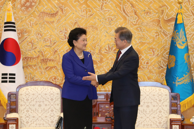 South Korean President Moon Jae-in (R) shakes hands with Chinese Vice Premier Liu Yandong before the start of their meeting at the South Korean presidential office Cheong Wa Dae in Seoul on Feb. 26, 2018. (Yonhap)