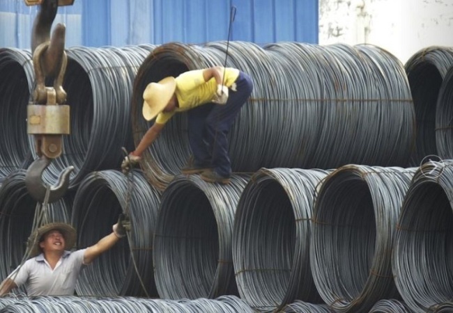 In this Aug. 1, 2016 photo, laborers work in the steel market in Yichang in central China’s Hubei province. (AP)