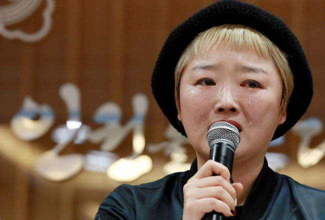 A victim of sexual violence speaks at a press conference. (Yonhap)