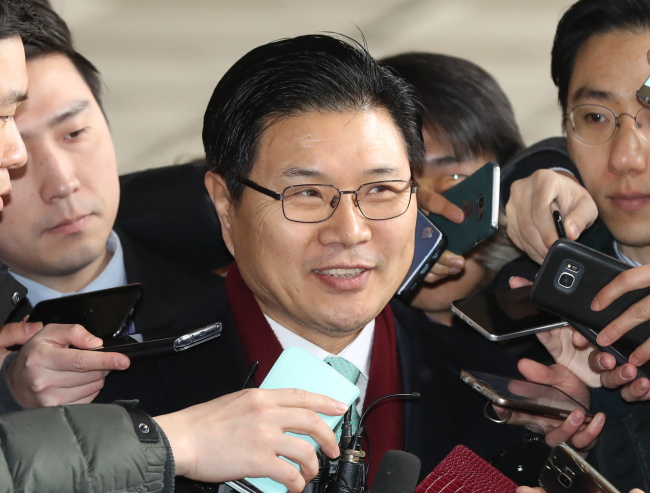 Rep. Hong Moon-jong of the main opposition Liberty Korea Party answers reporters' questions on Friday, as he appeared for prosecution questioning over suspected use of illegal political funds. (Yonhap)