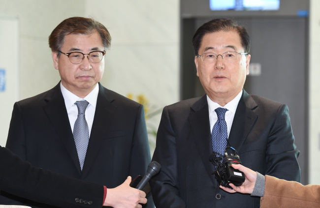 Chung Eui-yong, head of South Korea's National Security Office (R) answers questions at Incheon International Airport after returning from a trip to the United States on March 11, 2018. (Yonhap)