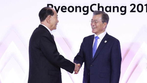 South Korea's President Moon Jae-in shakes hands with North Korea's nominal head of state Kim Young-nam. Yonhap