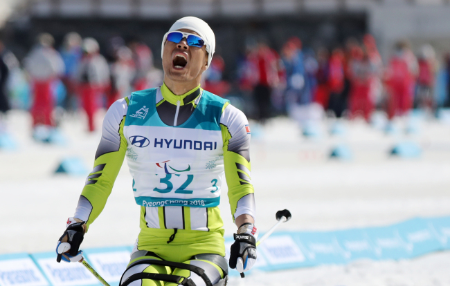 North Korea's Ma Yu-chol reacts after finishing the men's 1.1 kilometer sprint sitting cross-country skiing event of the PyeongChang Winter Paralympics at Alpensia Biathlon Centre in PyeongChang, Gangwon Province on Wednesday. (Yonhap)