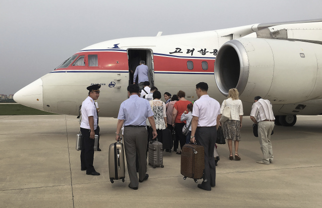 In this June 27, 2016, file photo, passengers board an Air Koryo flight headed for Beijing in Pyongyang, North Korea. (AP-Yonhap)