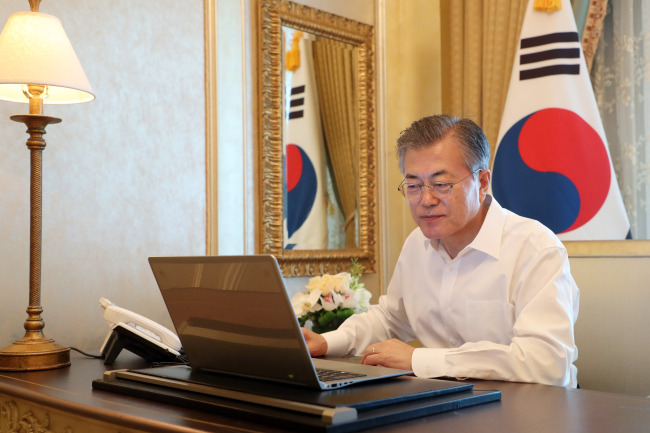 President Moon Jae-in approves the submission of the government's Constitution revision bill during his visit to the United Arab Emirates on Monday. Yonhap