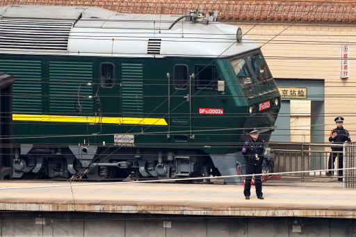Police officers keep watch next to a train at the Beijing Railway Station in Beijing, China March 27, 2018. (REUTERS - Yonhap)