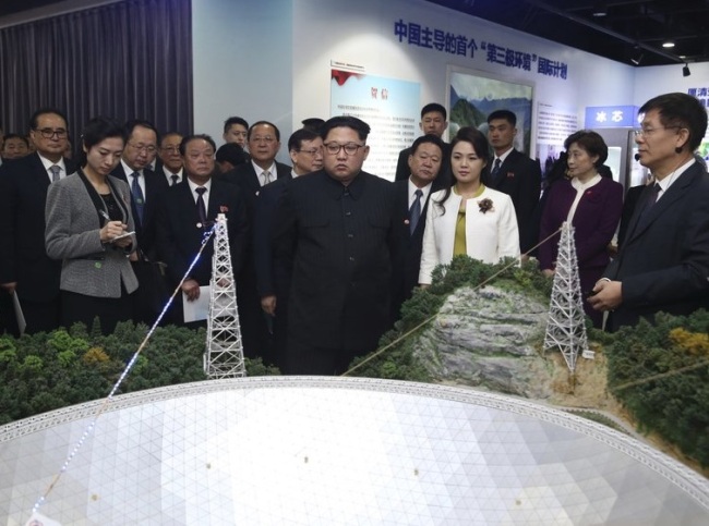 North Korean leader Kim Jong Un, center, and his wife Ri Sol Ju, visit an exhibition highlighting achievements by the Chinese Academy of Sciences on Wednesday, March 28. (Xinhua-AP)