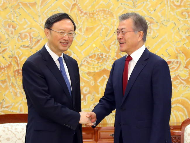 South Korea's President shakes hands with the Chinese State Councilor Yang Jiechi during thier meeting at Cheong Wa Dae Friday. Yonhap
