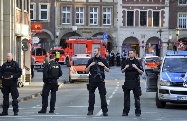 Police officers secure the crime scene after a car crashed into a group of people leaving several dead in Muenster, Germany, Saturday, April 7. (AP)