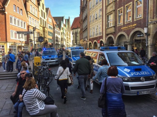 Police vans stand in downtown Muenster, Germany, Saturday, April 7. German news agency dpa says several people killed after car crashes into crowd in city of Muenster. (AP)