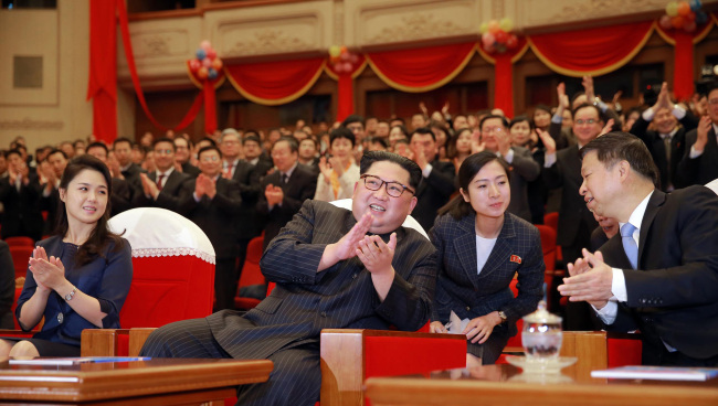 North Korean leader Kim Jong-un (second from left) and his wife Ri Sol-ju watches a ballet choreodrama of "Red Women Company" by the Chinese art troupe on Monday, April 16. (Yonhap)